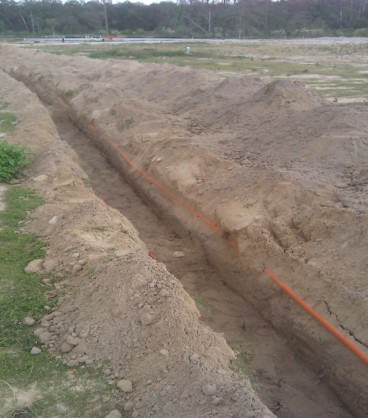 Trenching with existing fiber optic lines parallel to the ditch