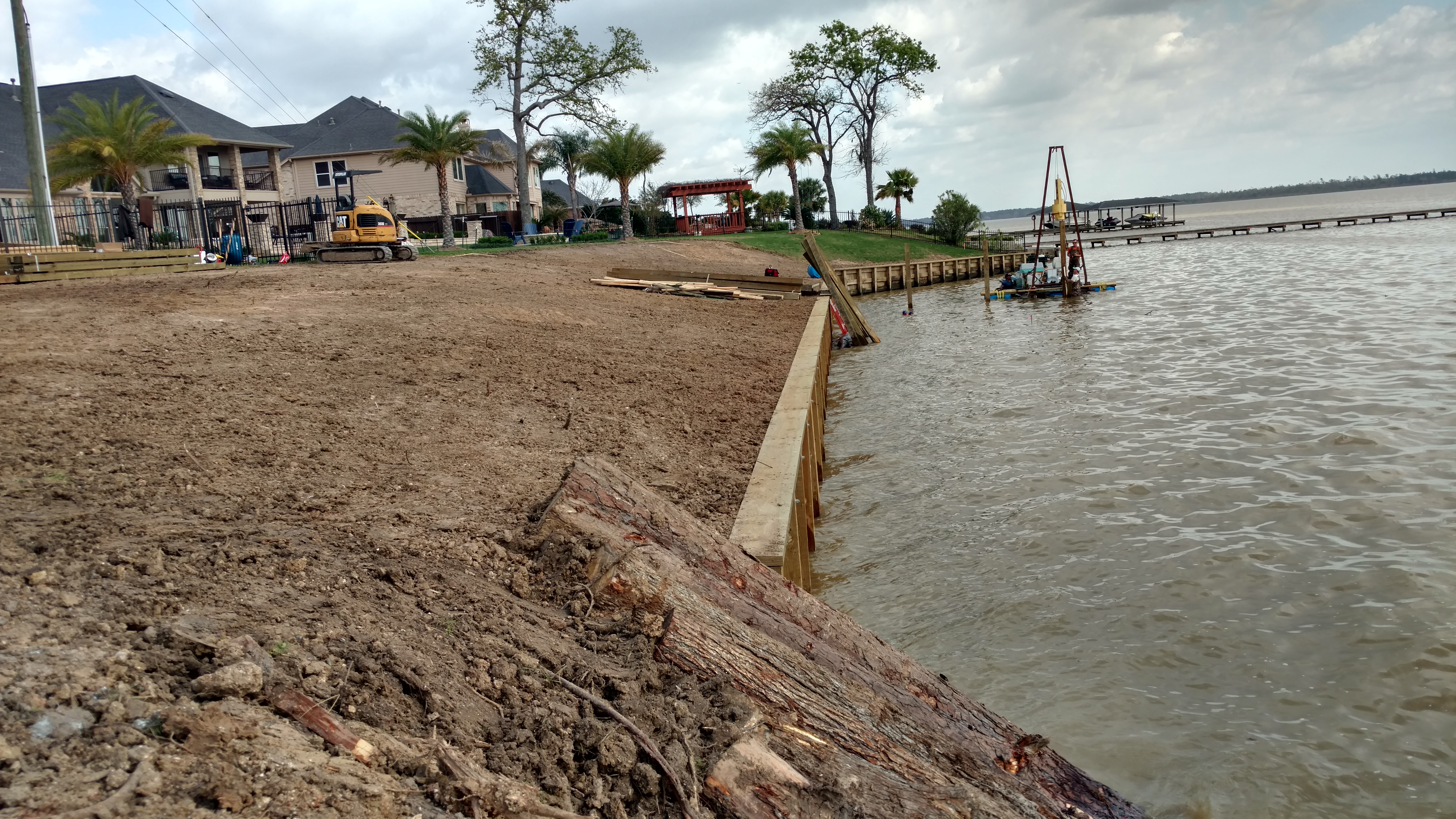 wood bulkhead construction and grading on lake houston